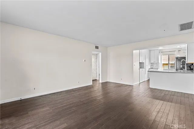 a view of an empty room and wooden floor