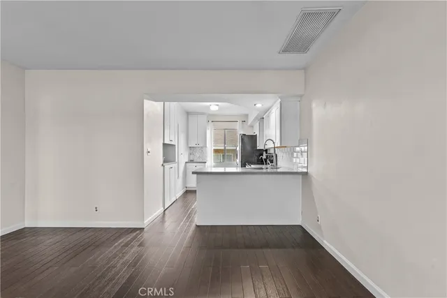 a view of kitchen with wooden floor and electronic appliances