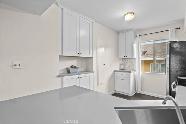a kitchen with stainless steel appliances a refrigerator sink and cabinets