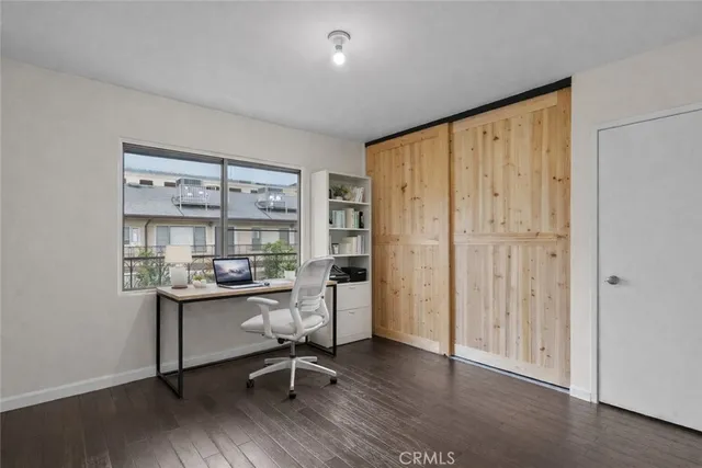 a view of a workspace with furniture and a window
