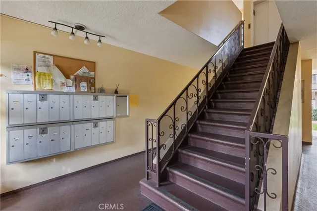 a view of room with wooden floor and staircase