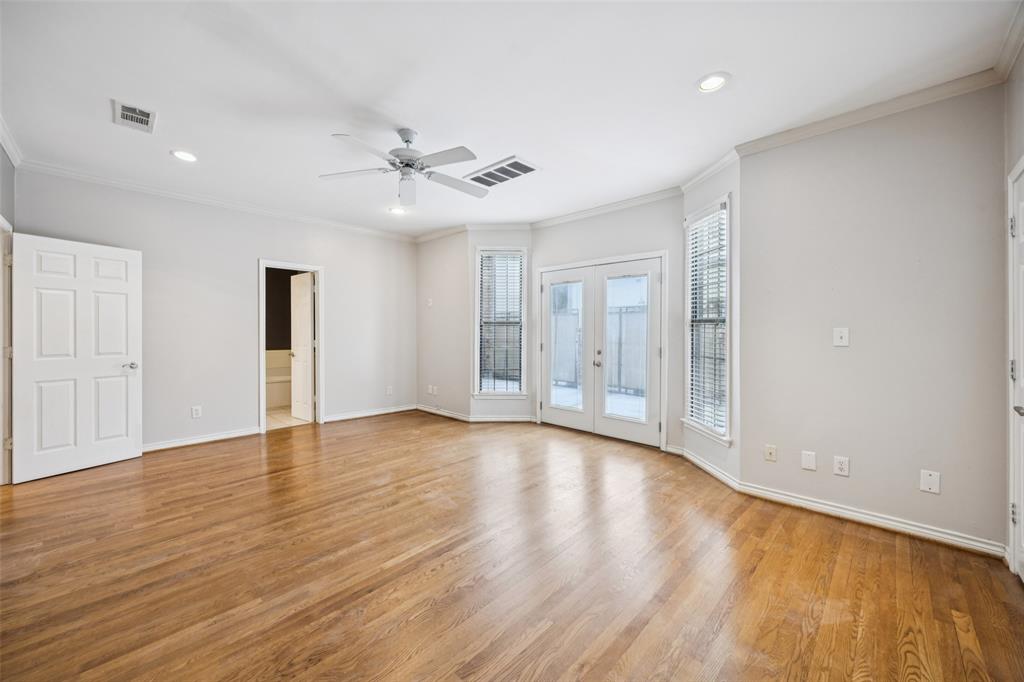 4511 Gilbert Avenue, Unit 103 Dallas, TX 75219 - Photo 11 of 35 a view of an empty room with window and wooden floor