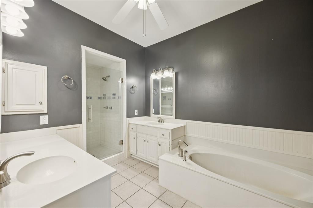 4511 Gilbert Avenue, Unit 103 Dallas, TX 75219 - Photo 12 of 35 a bathroom with a tub sink and mirror