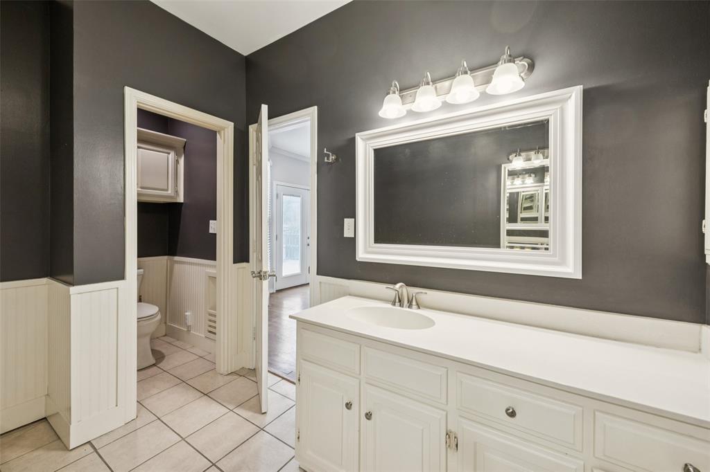 4511 Gilbert Avenue, Unit 103 Dallas, TX 75219 - Photo 13 of 35 a bathroom with a double vanity sink mirror and