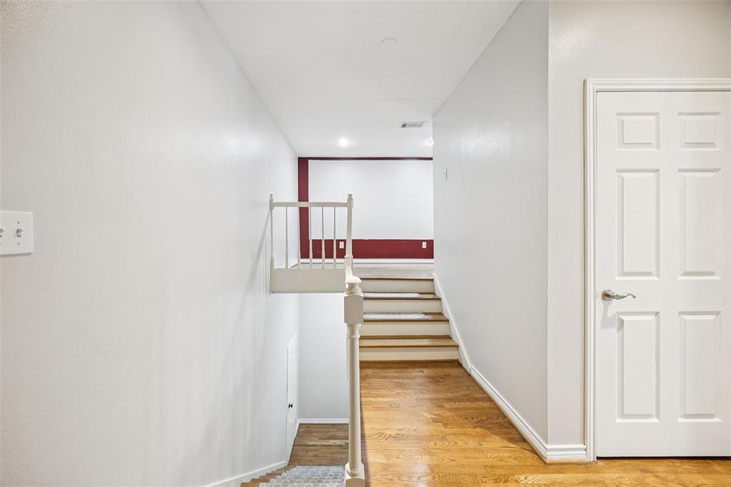 4511 Gilbert Avenue, Unit 103 Dallas, TX 75219 - Photo 21 of 35 a view of a hallway with wooden floor and entryway