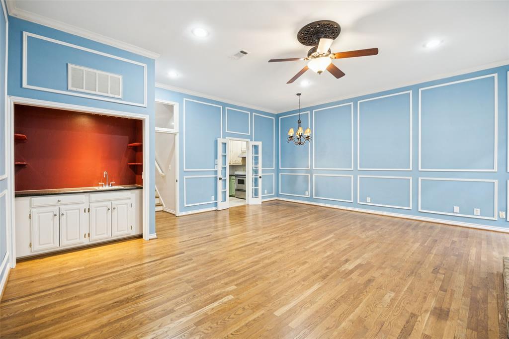 4511 Gilbert Avenue, Unit 103 Dallas, TX 75219 - Photo 3 of 35 a view of an empty room with a kitchen