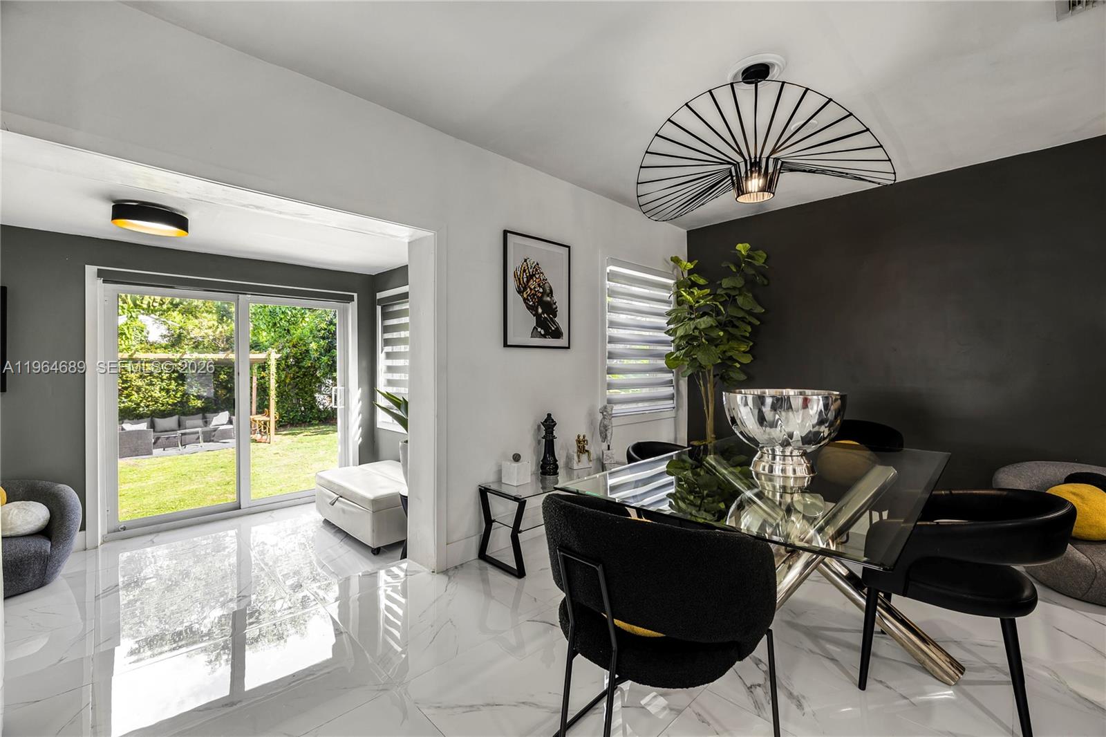 285 Northwest 45th Street Miami, FL 33127 - Photo 13 of 39 a living room with furniture and a floor to ceiling window