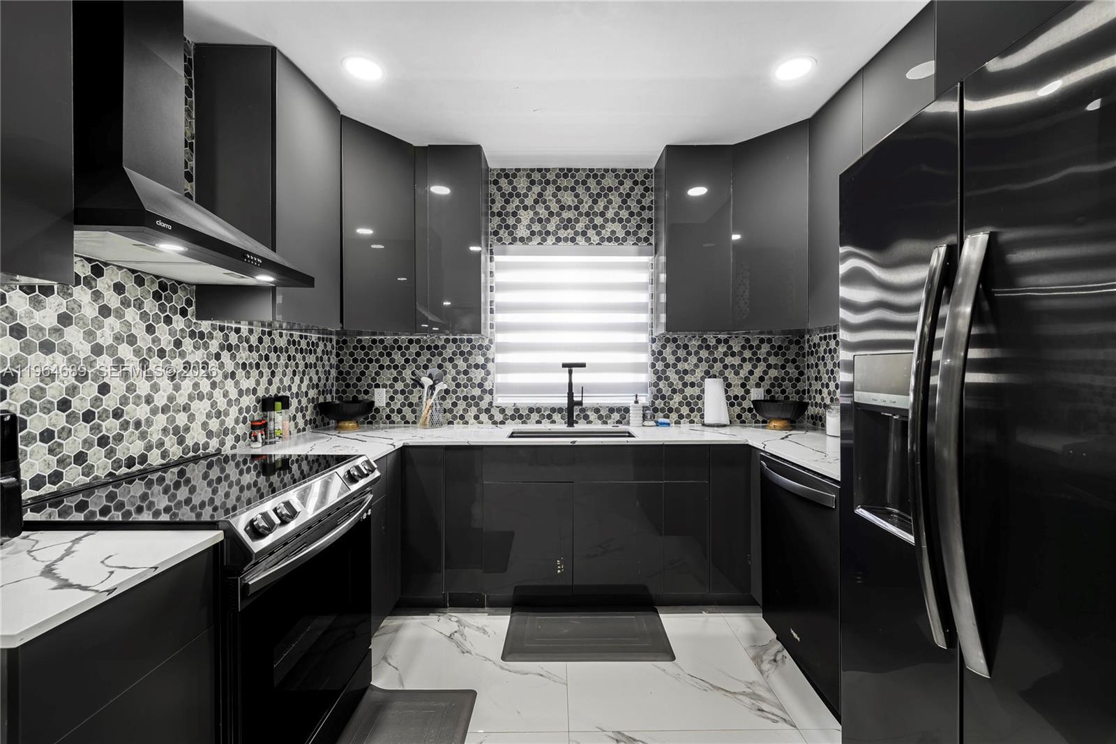 285 Northwest 45th Street Miami, FL 33127 - Photo 16 of 39 a kitchen with a sink and stove
