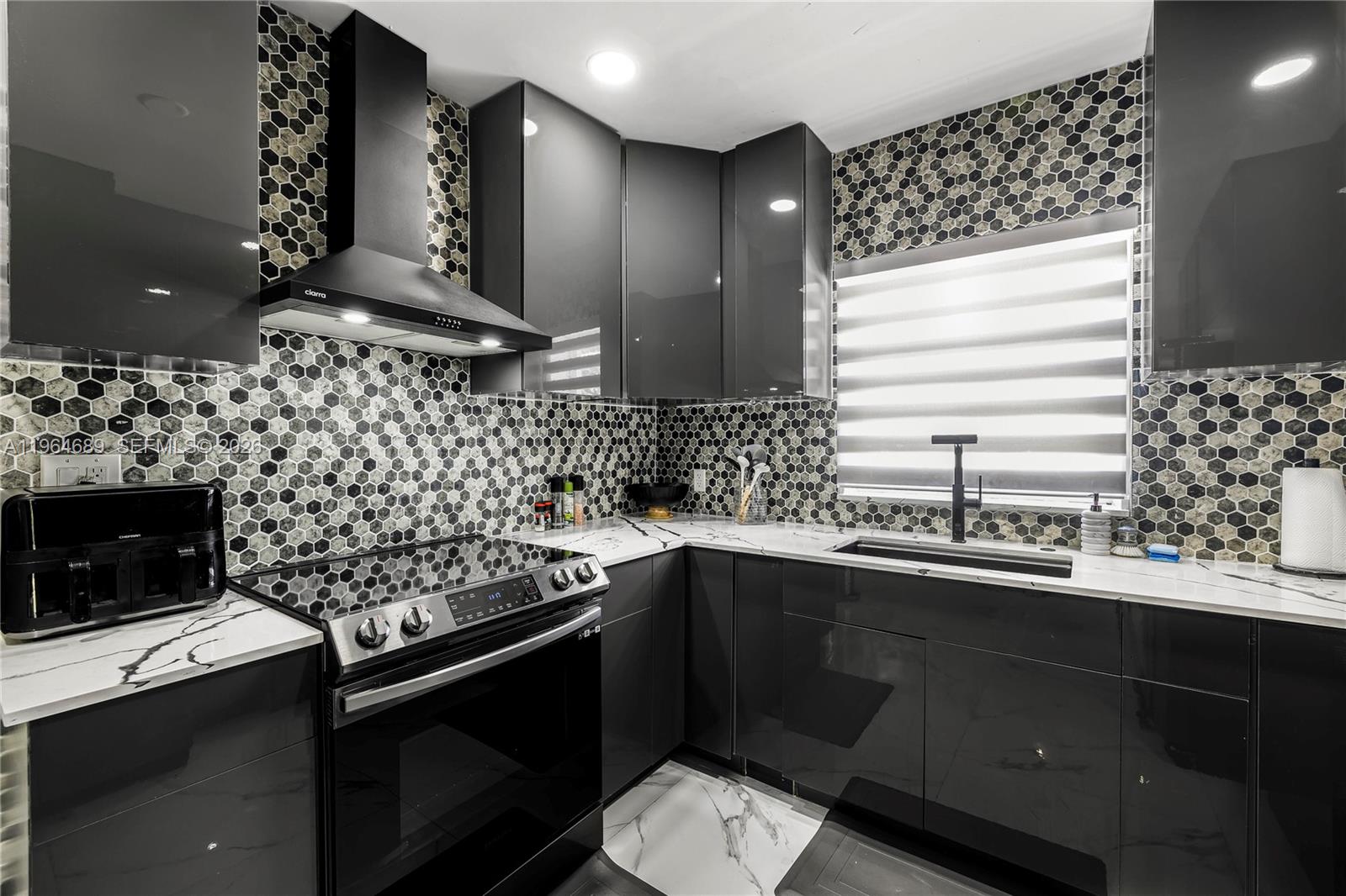 285 Northwest 45th Street Miami, FL 33127 - Photo 17 of 39 a kitchen with a sink stove and microwave
