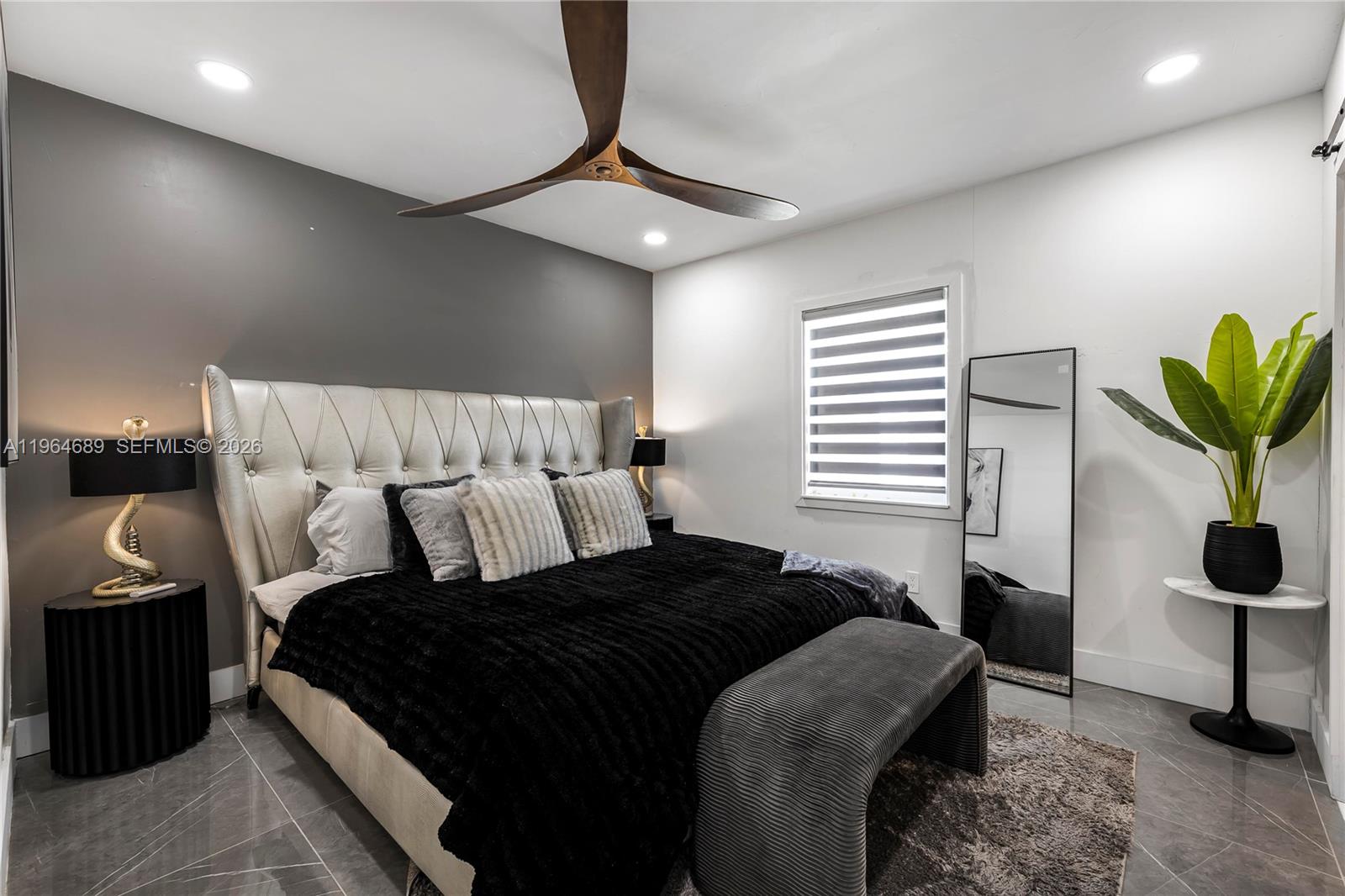 285 Northwest 45th Street Miami, FL 33127 - Photo 18 of 39 a bedroom with a bed and a chandelier