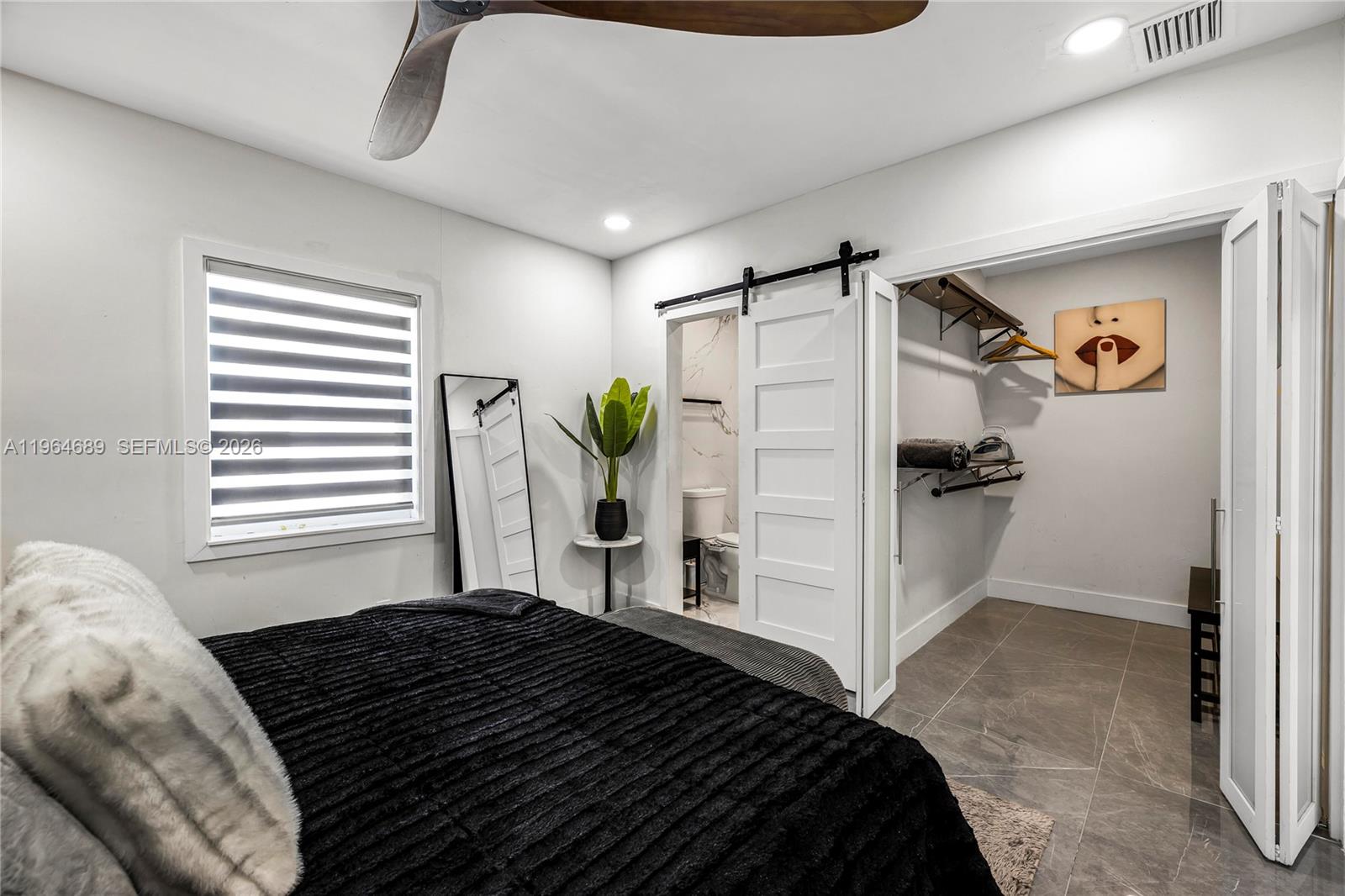 285 Northwest 45th Street Miami, FL 33127 - Photo 19 of 39 a bedroom with a bed and a window