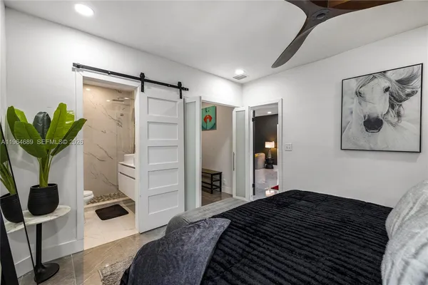 a bedroom with a bed and a potted plant