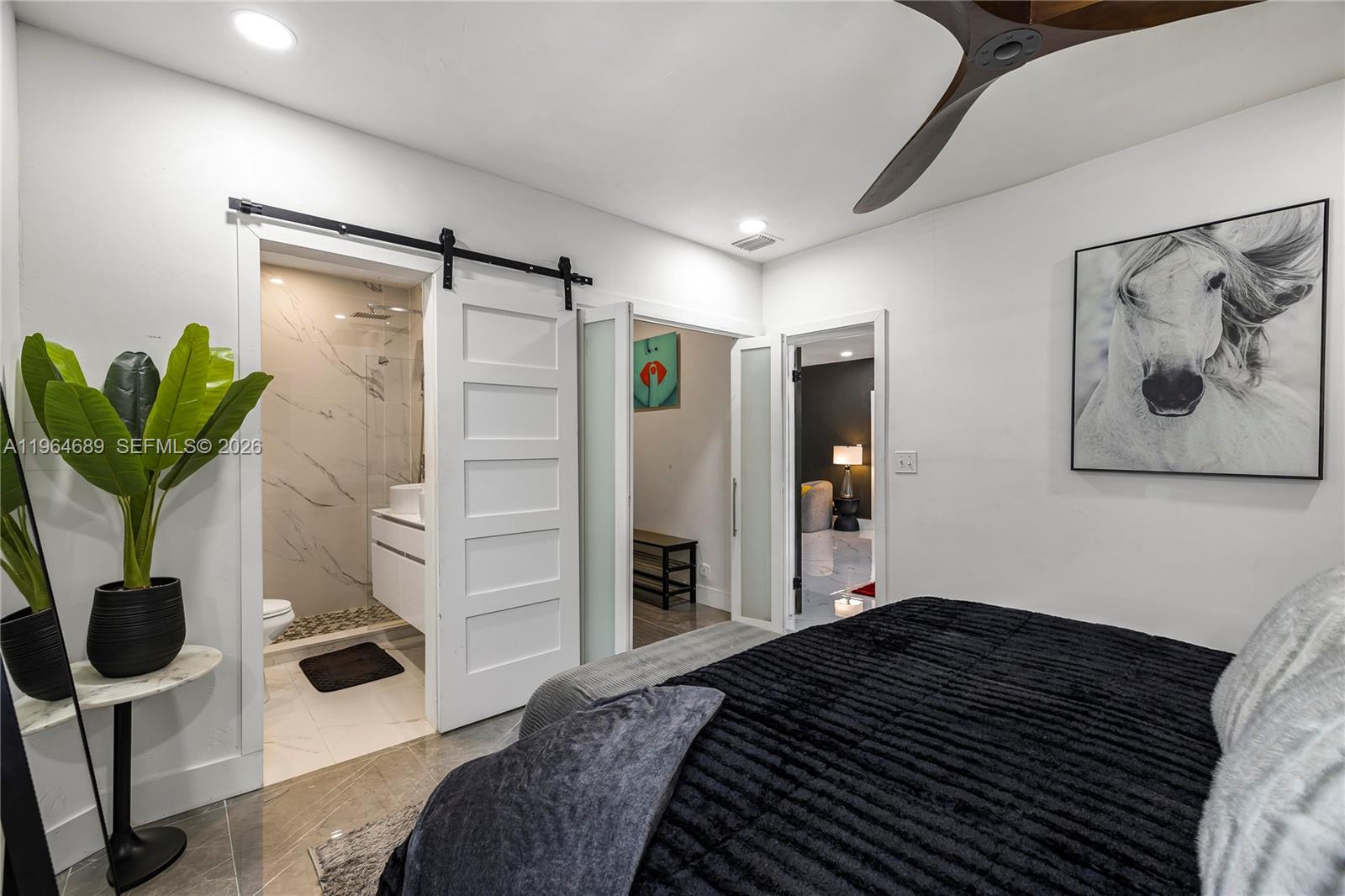 285 Northwest 45th Street Miami, FL 33127 - Photo 20 of 39 a bedroom with a bed and a potted plant