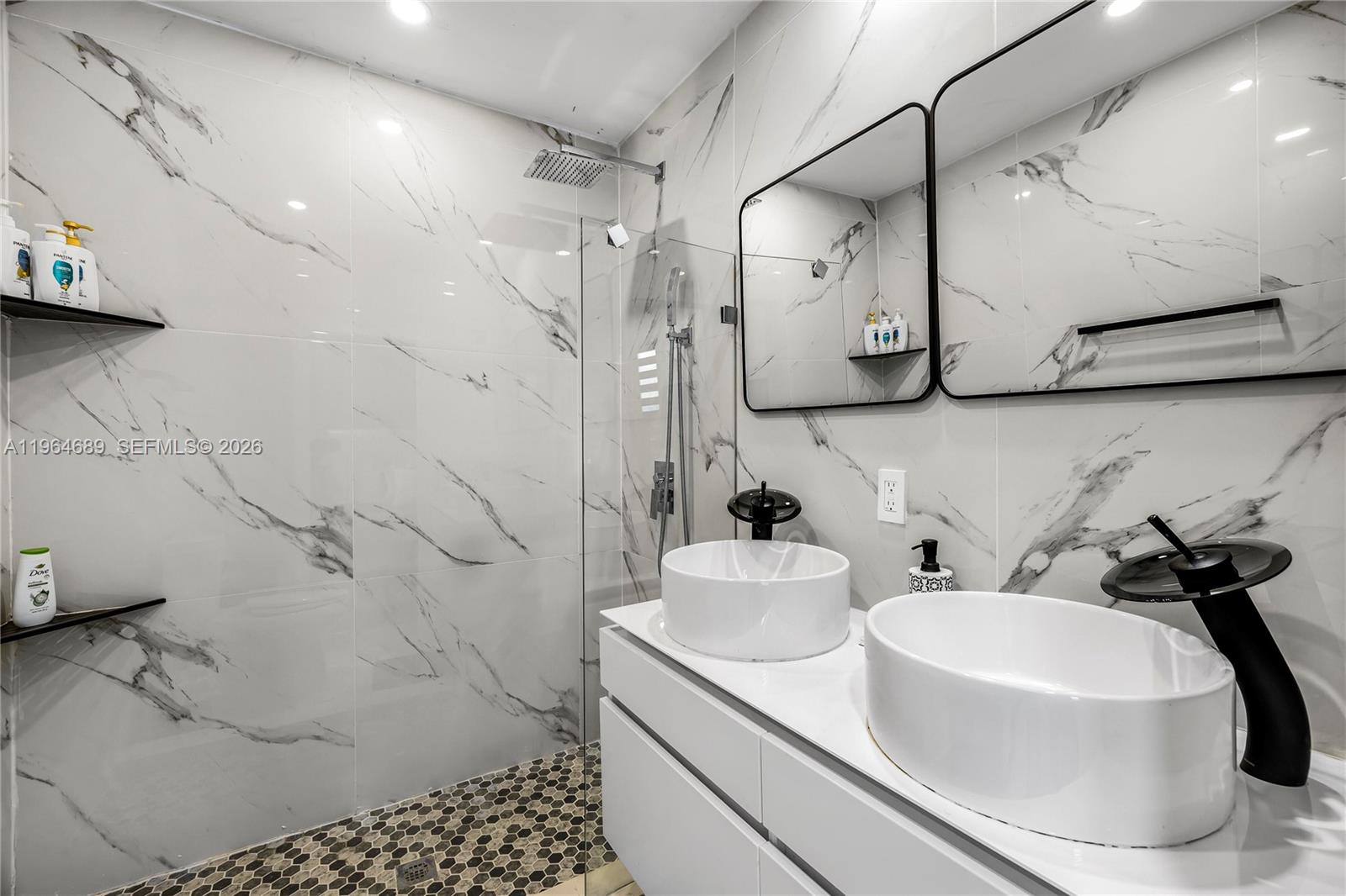285 Northwest 45th Street Miami, FL 33127 - Photo 22 of 39 a bathroom with a sink and a mirror