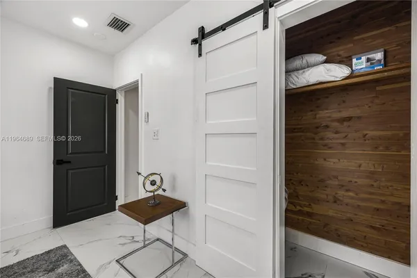 a bedroom with two beds and a window