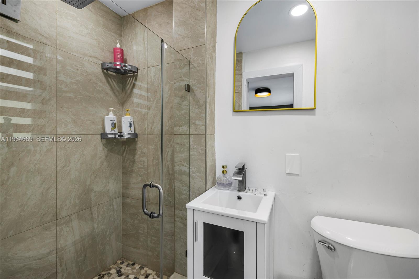 285 Northwest 45th Street Miami, FL 33127 - Photo 30 of 39 a bathroom with a toilet sink vanity and shower
