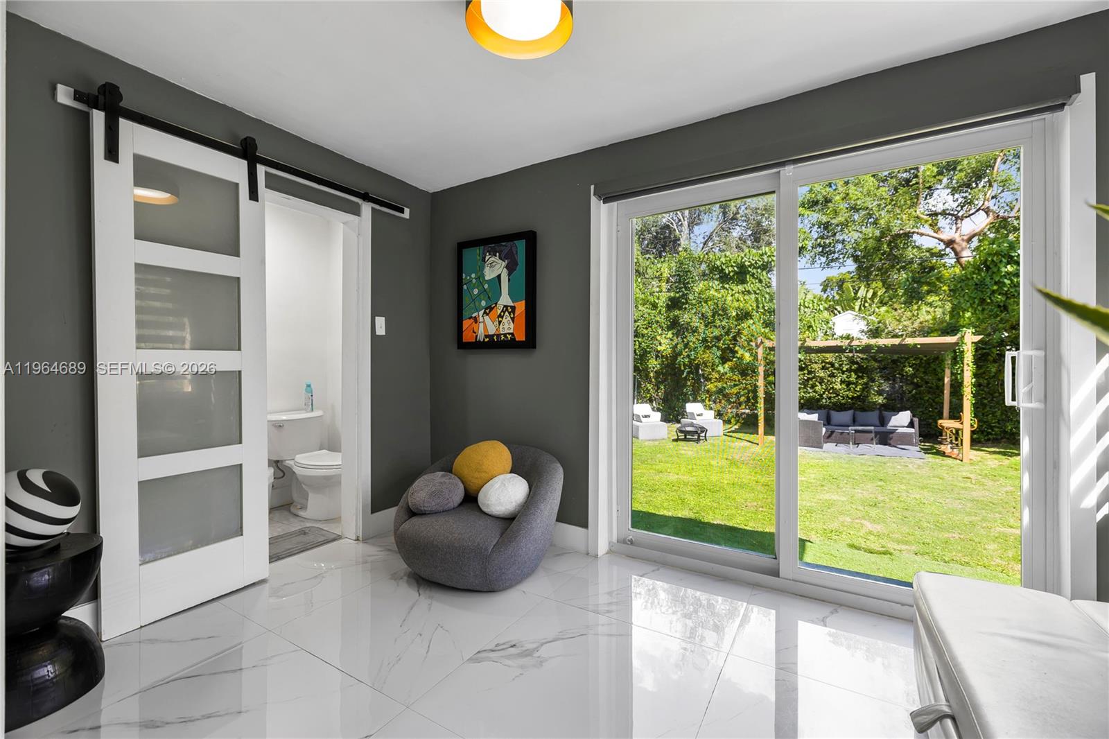 285 Northwest 45th Street Miami, FL 33127 - Photo 31 of 39 a view of a porch with furniture and garden