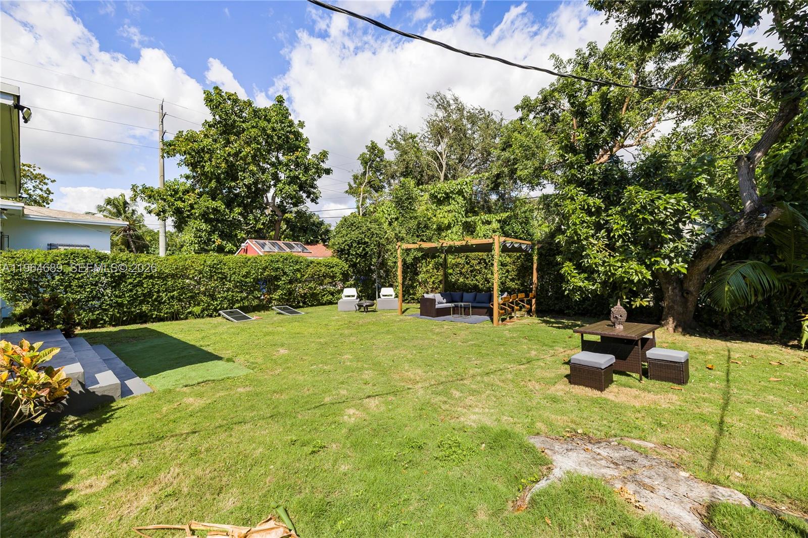 285 Northwest 45th Street Miami, FL 33127 - Photo 36 of 39 a backyard of a house with table and chairs potted plants