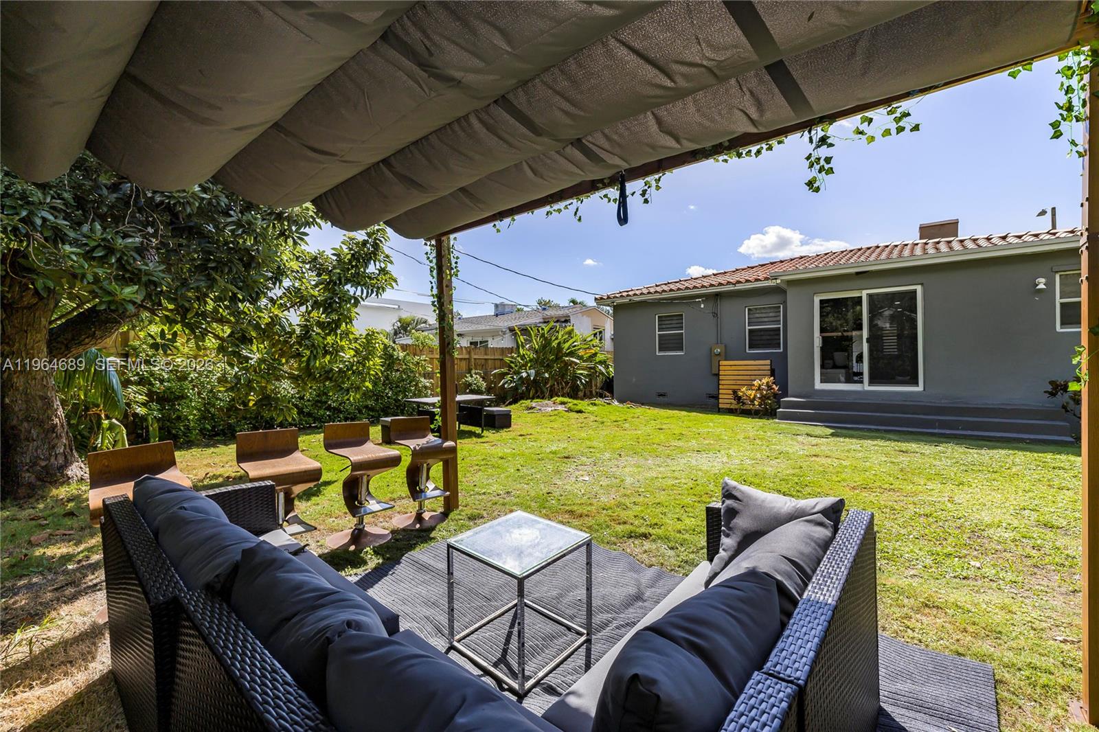 285 Northwest 45th Street Miami, FL 33127 - Photo 38 of 39 a view of a patio with couches chairs under an umbrella