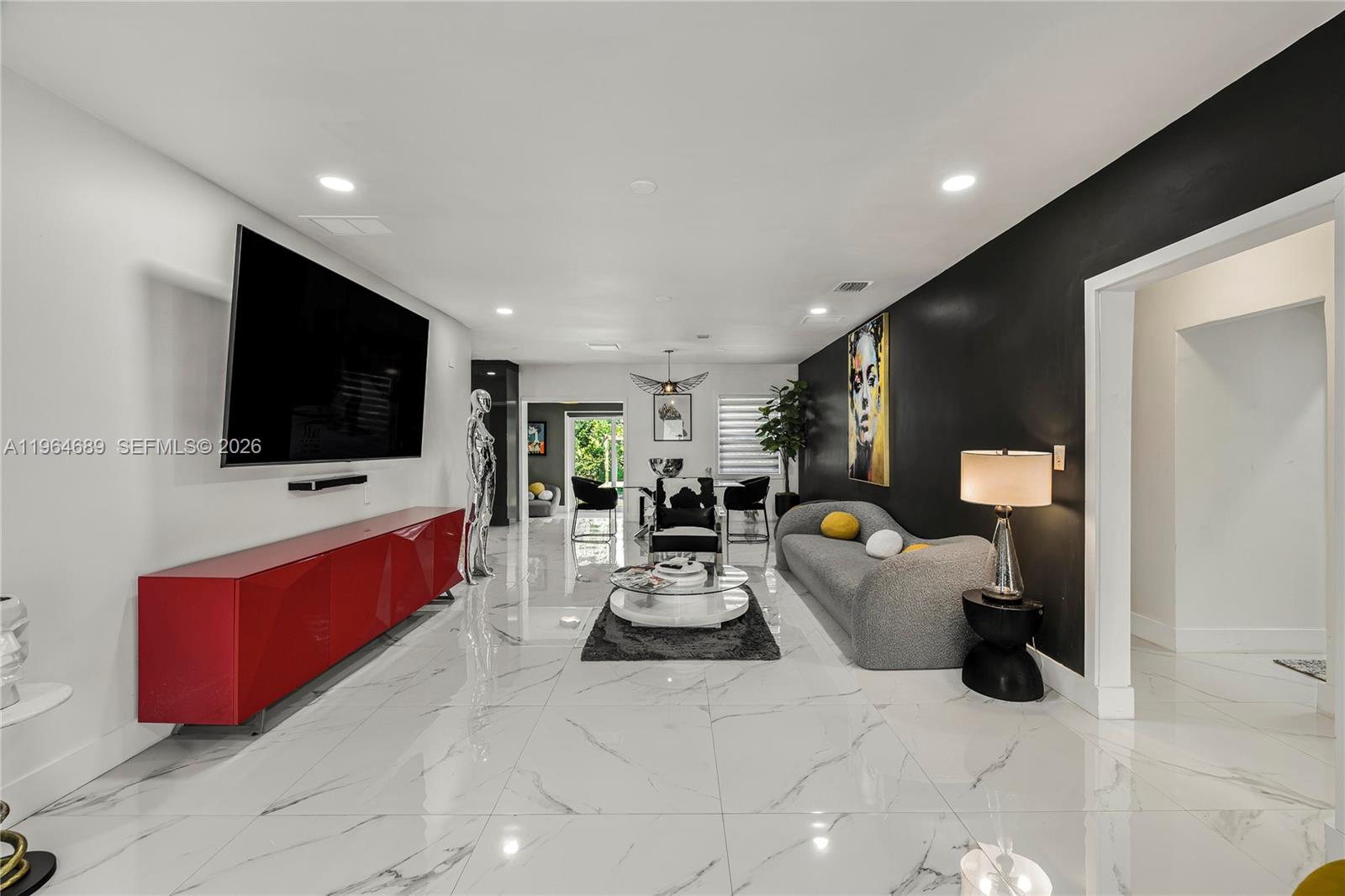 285 Northwest 45th Street Miami, FL 33127 - Photo 5 of 39 a living room with furniture and a flat screen tv