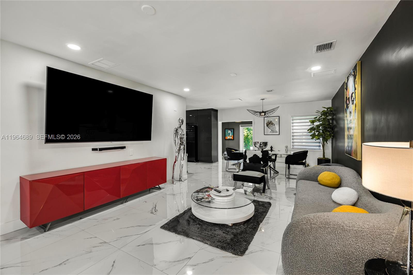 285 Northwest 45th Street Miami, FL 33127 - Photo 6 of 39 a living room with furniture and a flat screen tv