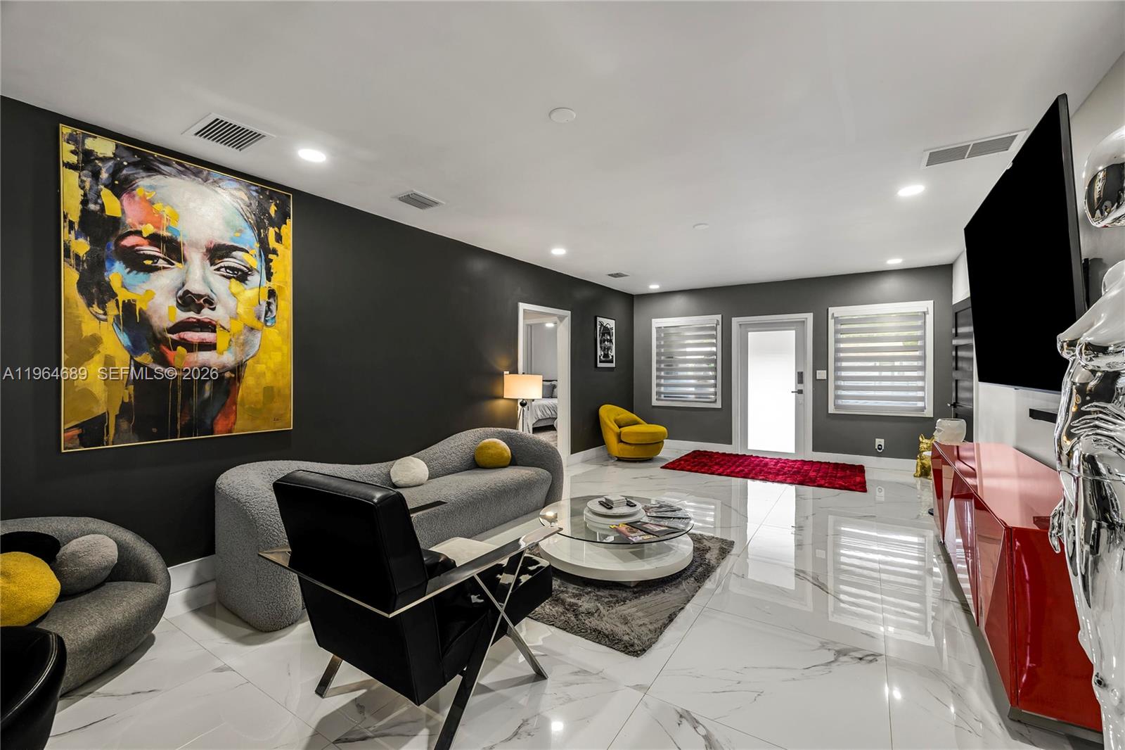 285 Northwest 45th Street Miami, FL 33127 - Photo 8 of 39 a living room with furniture and a flat screen tv