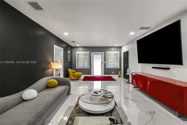 a living room with furniture and a flat screen tv