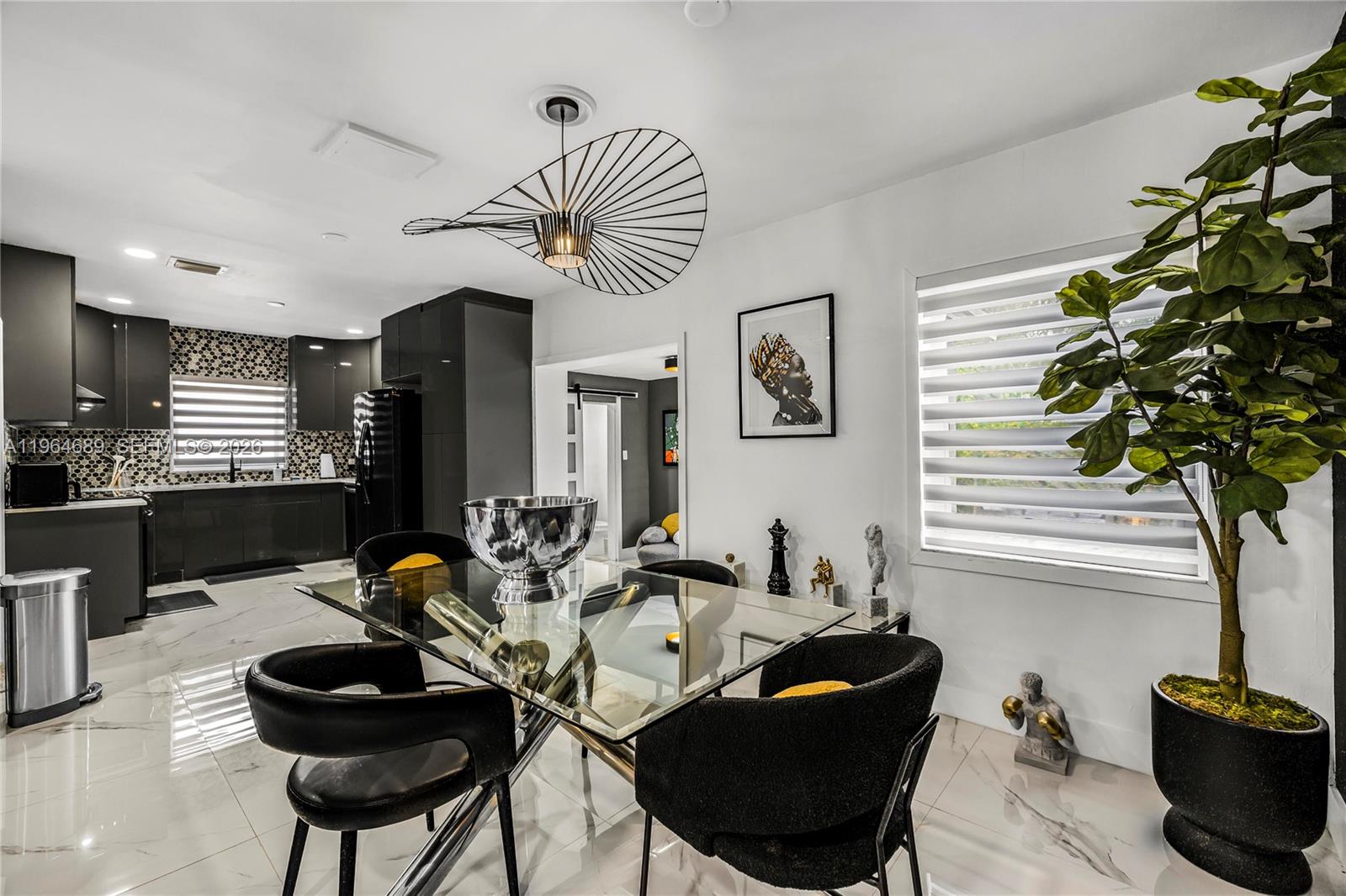 285 Northwest 45th Street Miami, FL 33127 - Photo 10 of 39 a living room with furniture potted plant and a window
