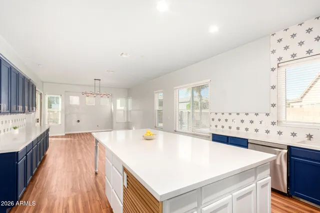 a large white kitchen with a large window