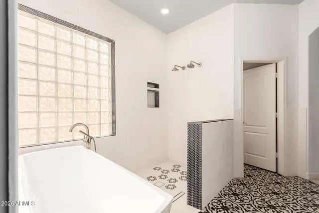 a bathroom with a bathtub and a window