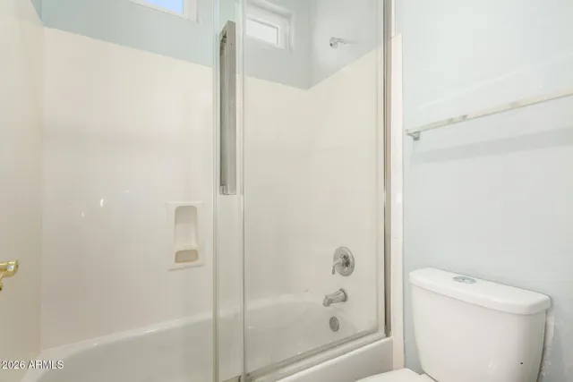 a bathroom with a bathtub and a toilet