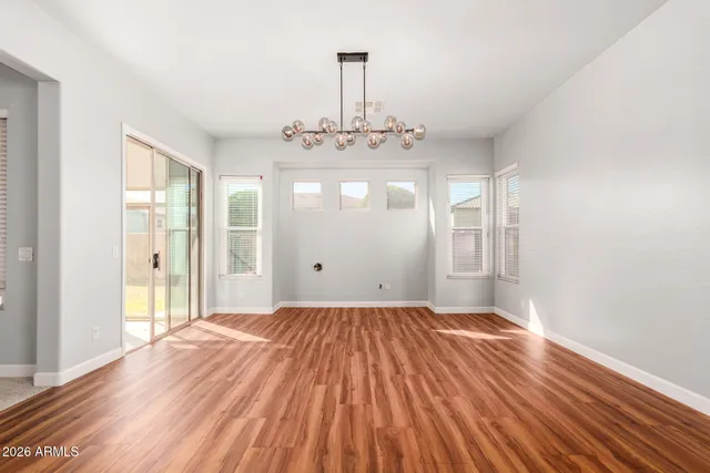 a view of a room with wooden floor and window