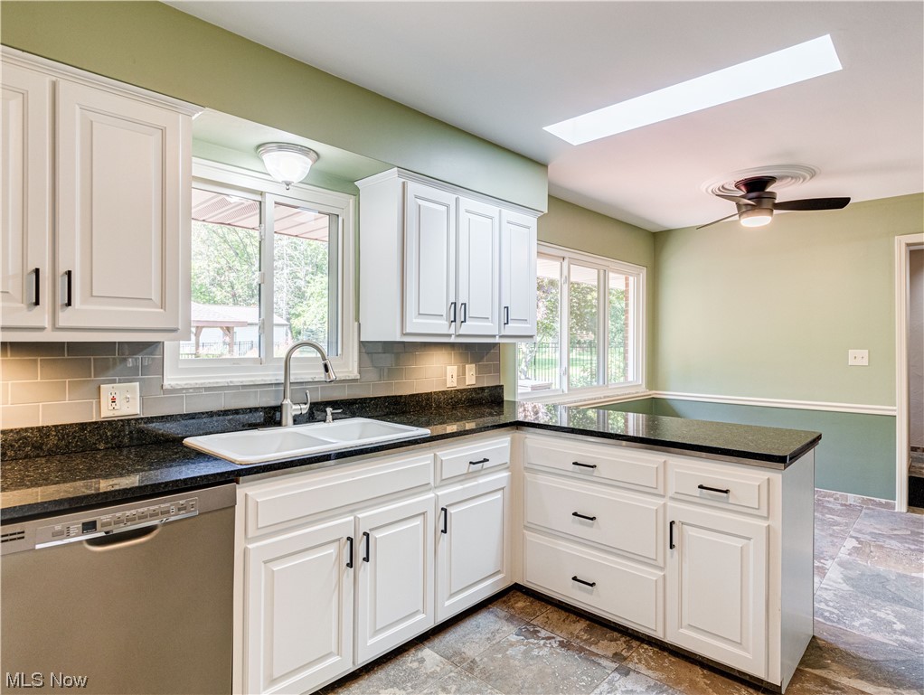 940 North Hametown Road Akron, OH 44333 - Photo 13 of 34 Under cabinet lighting, a skylight, and tasteful backsplash