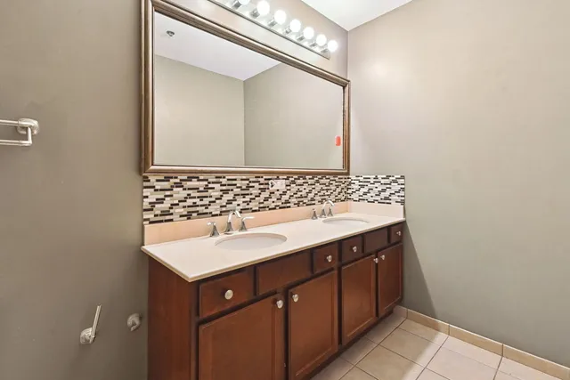 a bathroom with a sink a toilet and mirror