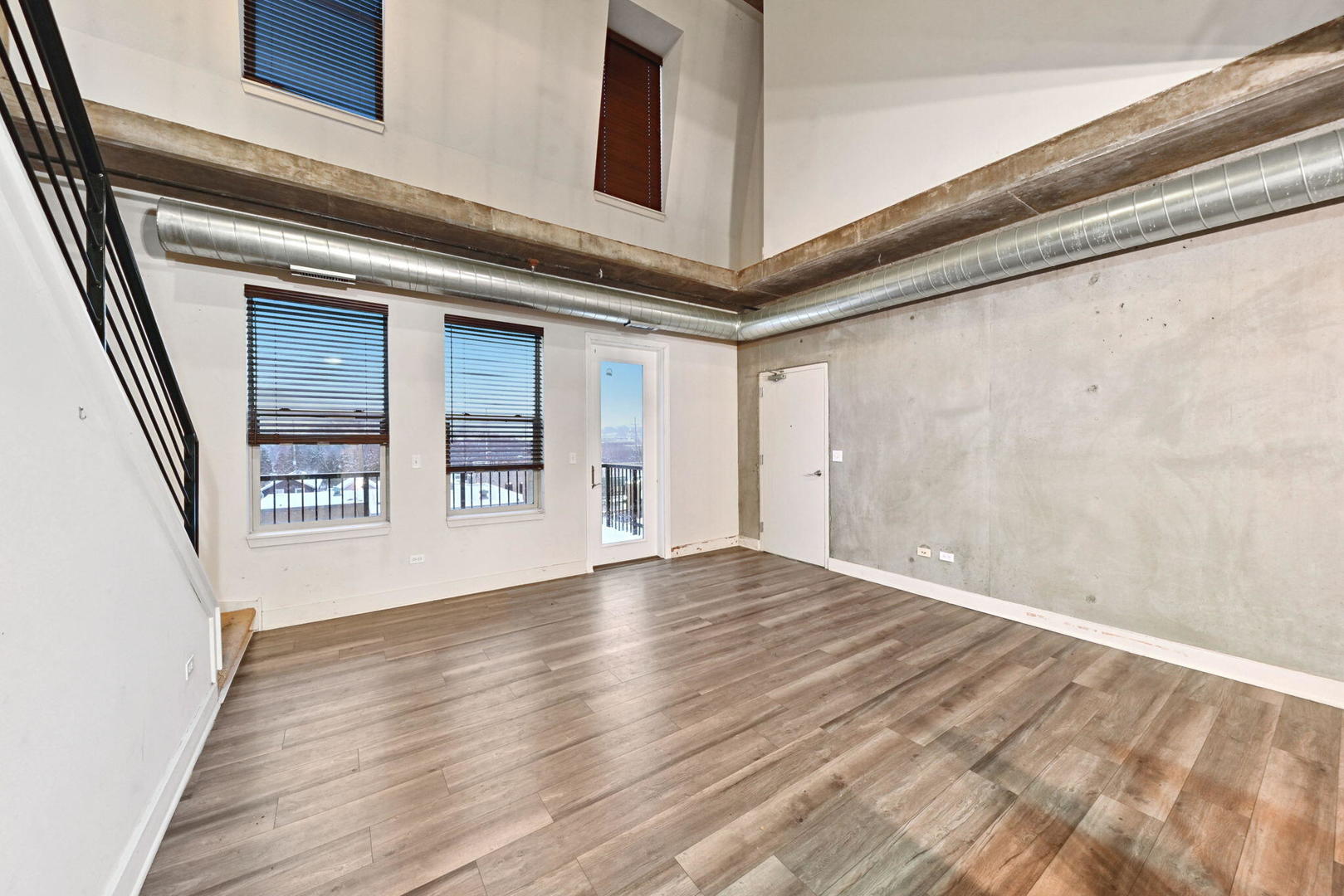 342 River Street, Unit 3402 Lemont, IL 60439 - Photo 4 of 25 a view of an empty room with wooden floor and a window