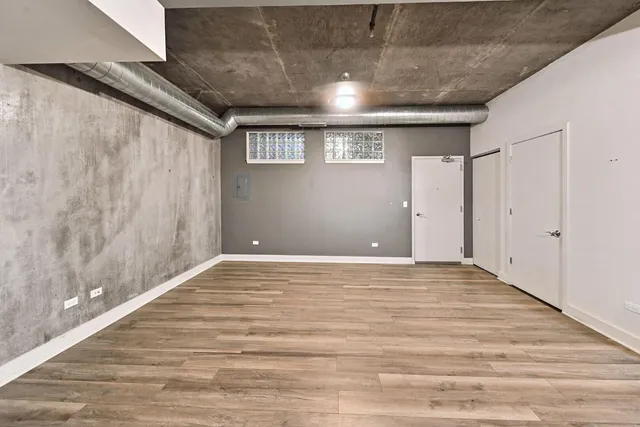 a view of a kitchen with granite countertop wooden floor a dining table and chairs