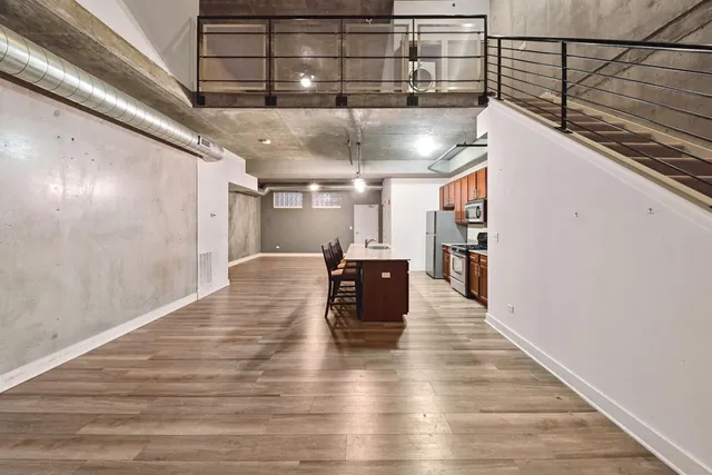 a view of a kitchen with furniture and wooden floor