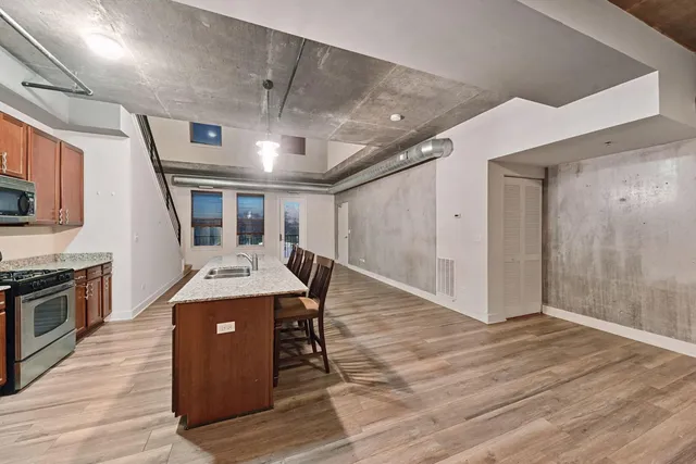 a view of a room with wooden floor