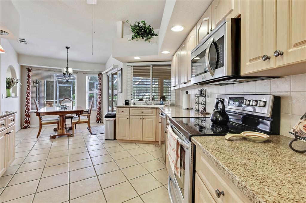 3786 South Emma Jane Terrace Homosassa, FL 34448 - Photo 12 of 32 a kitchen with stainless steel appliances granite countertop sink stove and cabinets