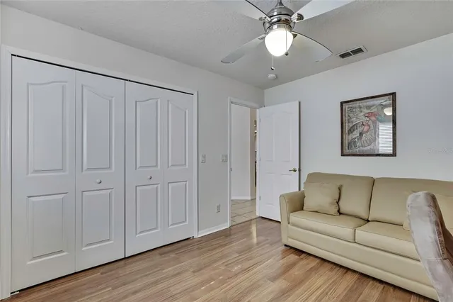 a living room with furniture and a ceiling fan