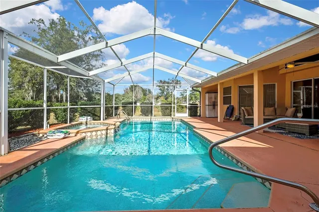 a view of a backyard with table and chairs under an umbrella