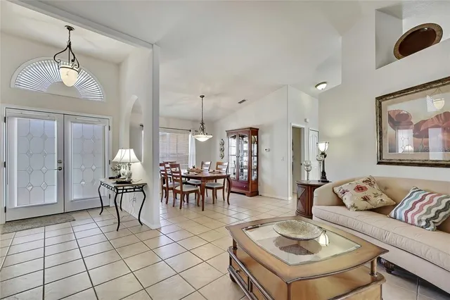 a living room with furniture and a dining table with kitchen view