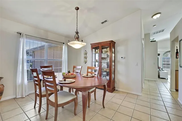 a view of a dining room with furniture and a chandelier