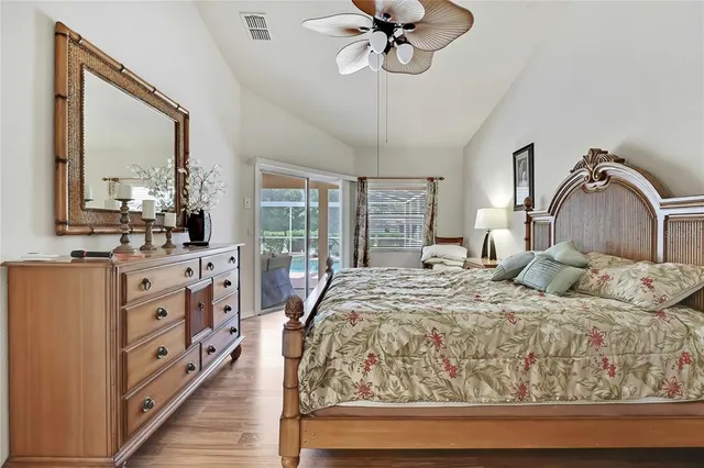 a bedroom with a large bed and a chandelier