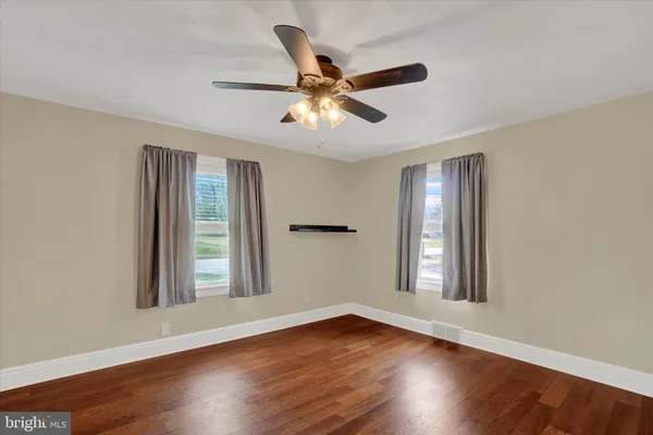 a view of wooden floor and windows in a room