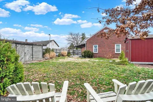 a view of house with backyard space and garden