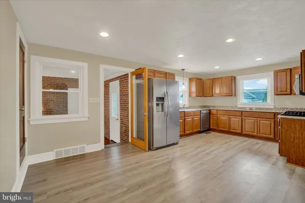 a kitchen with stainless steel appliances a refrigerator and a sink
