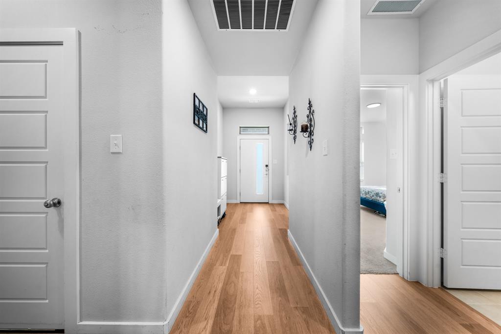 1012 Breezy Street Princeton, TX 75407 - Photo 16 of 34 a view of a hallway with wooden floor and staircase