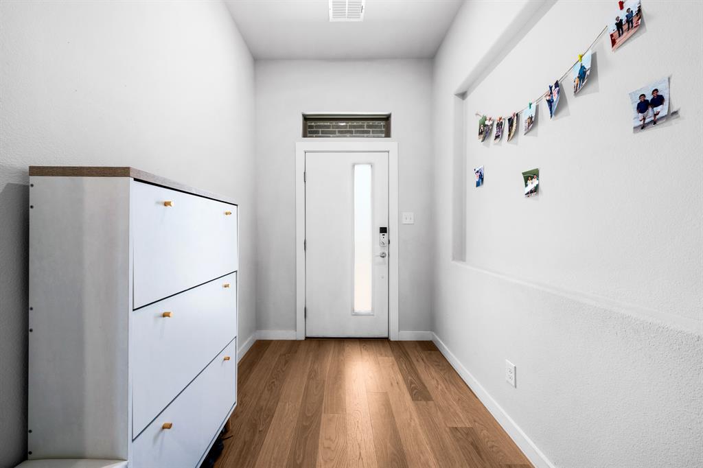 1012 Breezy Street Princeton, TX 75407 - Photo 17 of 34 a view of utility room with closet and wooden floor