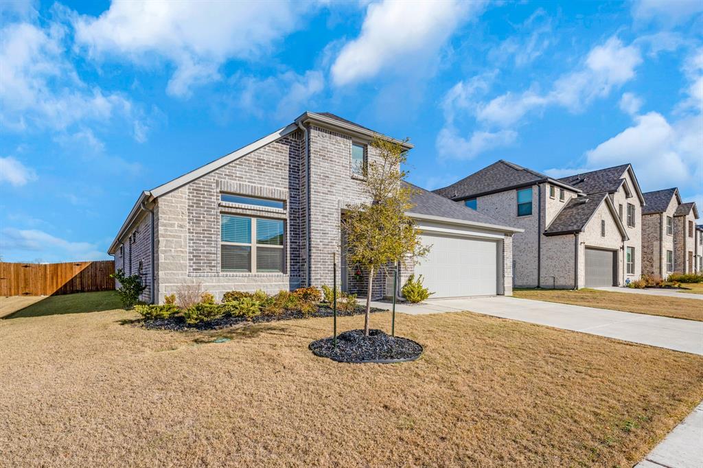 1012 Breezy Street Princeton, TX 75407 - Photo 30 of 34 a front view of a house with garden